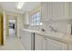 Laundry room with a washer, dryer, sink, and lots of cabinets at 7655 Pesaro Dr, Sarasota, FL 34238