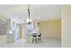 Open-concept living room and dining area with views to kitchen, and lots of natural light at 7655 Pesaro Dr, Sarasota, FL 34238