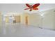 Open-concept living room with tile floors and views into the kitchen area with bar seating at 7655 Pesaro Dr, Sarasota, FL 34238