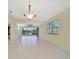 Bright living room with tile flooring and a large window with a view of the outside at 7655 Pesaro Dr, Sarasota, FL 34238