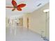 Open-concept living room with tile floors and views into the kitchen area with bar seating at 7655 Pesaro Dr, Sarasota, FL 34238