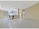 Bright and airy living area flowing into the kitchen, featuring sleek tile flooring and ample space at 7655 Pesaro Dr, Sarasota, FL 34238