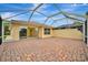 Paver patio perfect for entertaining or enjoying outdoor living, accessible through sliding glass doors at 7655 Pesaro Dr, Sarasota, FL 34238