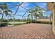 Enclosed patio with brick pavers and water view, perfect for outdoor entertaining and relaxation at 7655 Pesaro Dr, Sarasota, FL 34238