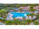 Resort-style pool with ample seating, shaded areas, and lush tropical landscaping at 7655 Pesaro Dr, Sarasota, FL 34238