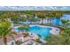 Stunning community pool area with lake views, palm trees, and plenty of seating at 7655 Pesaro Dr, Sarasota, FL 34238