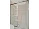 Modern shower with glass enclosure and white tiled walls at 7655 Pesaro Dr, Sarasota, FL 34238