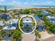 An aerial view of the beautiful home's proximity to the beach with lush greenery surrounding the property at 785 Jacaranda Rd, Anna Maria, FL 34216