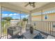 Inviting screened-in balcony with comfortable seating and scenic neighborhood views, perfect for outdoor relaxation at 785 Jacaranda Rd, Anna Maria, FL 34216
