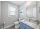Well-lit bathroom with granite countertops and a large mirror at 785 Jacaranda Rd, Anna Maria, FL 34216