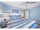 Cozy bedroom with blue accents, a comfortable bed, and ample lighting, creating a relaxing and inviting atmosphere at 785 Jacaranda Rd, Anna Maria, FL 34216