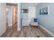 Charming bedroom featuring a wall-mounted TV and a comfortable seating area at 785 Jacaranda Rd, Anna Maria, FL 34216