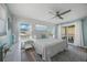 Well-lit bedroom with white shiplap walls and access to an outdoor balcony, offering a tranquil retreat at 785 Jacaranda Rd, Anna Maria, FL 34216
