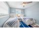 Cozy bedroom with twin beds, a ceiling fan, and nautical-themed decor at 785 Jacaranda Rd, Anna Maria, FL 34216