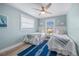 Twin bedroom with a coastal design, featuring crisp white bedding, blue accents, and natural light, creating a charming space at 785 Jacaranda Rd, Anna Maria, FL 34216