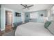 Comfortable bedroom with calming blue walls, modern amenities, and an attached bathroom, creating a serene space at 785 Jacaranda Rd, Anna Maria, FL 34216