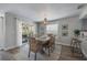 Dining room featuring a large table, lots of seating, a modern chandelier, and access to an outdoor patio at 785 Jacaranda Rd, Anna Maria, FL 34216