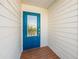 Charming home with a striking blue front door at 785 Jacaranda Rd, Anna Maria, FL 34216