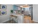 Stylish kitchen featuring blue cabinetry, granite countertops, and stainless steel appliances at 785 Jacaranda Rd, Anna Maria, FL 34216