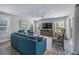 Relax in the bright and airy living room, featuring an open floor plan and modern coastal decor at 785 Jacaranda Rd, Anna Maria, FL 34216