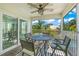 Relaxing screened-in porch with ceiling fan and comfortable outdoor furniture at 785 Jacaranda Rd, Anna Maria, FL 34216