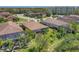 Aerial view shows homes with screened lanais, surrounded by green landscaping and trees at 8168 36Th E St, Sarasota, FL 34243