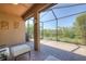 Screened lanai with brick flooring, comfortable seating, and serene outdoor views at 8168 36Th E St, Sarasota, FL 34243