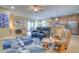 Bright living room featuring tile floors, a ceiling fan, and an open layout with easy access to the kitchen at 8168 36Th E St, Sarasota, FL 34243