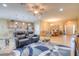 Open-concept living space with tile flooring, comfortable seating, and a well-lit dining area at 8168 36Th E St, Sarasota, FL 34243