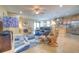 Bright living room with tile floors, ceiling fan, leather seating, and opens up to the kitchen at 8168 36Th E St, Sarasota, FL 34243