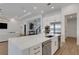 Kitchen island with dishwasher, wine cooler, and stainless steel appliances in an open floor plan at 8207 Nevis Run, Bradenton, FL 34202