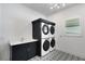 Well-equipped laundry room with stacked washer and dryer and stylish patterned floor at 8207 Nevis Run, Bradenton, FL 34202