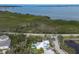 Aerial view of a house with pool, manicured landscaping, surrounded by natural vegetation at 8227 37Th Avenue W Cir, Bradenton, FL 34209
