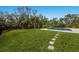 Lush backyard features stepping stones, a manicured lawn, and an inviting pool area at 8227 37Th Avenue W Cir, Bradenton, FL 34209