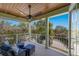 Spacious covered balcony boasts wood ceiling, ceiling fan, and relaxing outdoor seating area at 8227 37Th Avenue W Cir, Bradenton, FL 34209