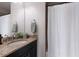 Neutral bathroom with granite countertop, dark cabinetry and an oversized shower at 8227 37Th Avenue W Cir, Bradenton, FL 34209