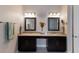 Elegant bathroom vanity with granite countertops, dual sinks, mirrors and modern lighting at 8227 37Th Avenue W Cir, Bradenton, FL 34209