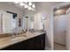 Elegant bathroom with dual sinks, granite countertop, beach-themed decor, and framed mirror at 8227 37Th Avenue W Cir, Bradenton, FL 34209