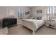 Bright bedroom with neutral color scheme, complemented by a classic black dresser and white accents at 8227 37Th Avenue W Cir, Bradenton, FL 34209