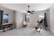 Spacious bedroom with neutral walls, three windows, ceiling fan, and exercise equipment at 8227 37Th Avenue W Cir, Bradenton, FL 34209