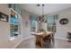 Dining area with large windows offering natural light and a rustic wood table at 8227 37Th Avenue W Cir, Bradenton, FL 34209