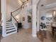 Spacious foyer with wood floors, a staircase with white railings, and views into the kitchen and living areas at 8227 37Th Avenue W Cir, Bradenton, FL 34209