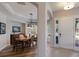 Welcoming foyer with wood floors flowing into dining room with a large dining table and front door at 8227 37Th Avenue W Cir, Bradenton, FL 34209