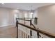 Upstairs hallway featuring neutral walls, carpet, and white railing leading to various rooms at 8227 37Th Avenue W Cir, Bradenton, FL 34209