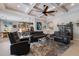Open-concept living room with a coffered ceiling, ceiling fan, and contemporary furnishings, perfect for entertaining at 8227 37Th Avenue W Cir, Bradenton, FL 34209