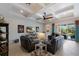 Bright and open living room with contemporary furnishings, a coffered ceiling, and seamless access to the outdoor area at 8227 37Th Avenue W Cir, Bradenton, FL 34209