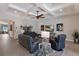 Comfortable living room features a coffered ceiling, a ceiling fan, and stylish decor with plush leather seating at 8227 37Th Avenue W Cir, Bradenton, FL 34209