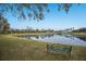 A bench overlooks a serene pond, providing a peaceful and relaxing outdoor space at 8227 37Th Avenue W Cir, Bradenton, FL 34209