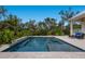 Beautiful pool area with lush greenery, a covered patio, and serene lounging space at 8227 37Th Avenue W Cir, Bradenton, FL 34209