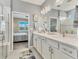 Bright bathroom with walk-in shower, double sinks, and clean finishes, offering a spa-like experience at 8309 Ocean Tides Cv, Parrish, FL 34219